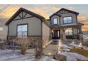 Two-story house with lights illuminating the walkway at dusk at 16686 Rinker Way, Broomfield, CO 80023