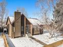 An attractive ranch-style home with a fenced yard and snowy landscaping at 245 Cedar St, Hudson, CO 80642