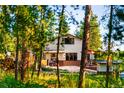 Home exterior surrounded by dense trees, providing privacy and a connection with nature at 200 The Lane Rd, Golden, CO 80403