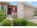 Inviting front entrance with a well-manicured lawn, stylish facade, and a cozy porch area at 17358 W 95Th Ave, Arvada, CO 80007