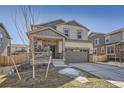 Two-story home with stone-accented porch, a two-car garage, and landscaping at 24274 E Walsh Ave, Aurora, CO 80018
