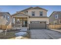 Charming two-story home featuring a covered porch with stone accents and a two-car garage at 24274 E Walsh Ave, Aurora, CO 80018