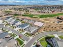 Aerial view of a residential neighborhood next to a lush golf course and a new sandbox at 11950 Mosey Ct, Parker, CO 80138