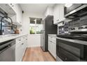 An updated kitchen featuring new stainless steel appliances, white cabinets, and butcher block counters at 4068 S Atchison Way # 103, Aurora, CO 80014