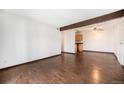 Open-concept living room features a wood beam and leads into the kitchen at 16359 W 10Th Ave # Yy3, Golden, CO 80401