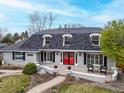 Beautiful home featuring an inviting front porch and well-manicured lawn at 5440 W Hinsdale Ave, Littleton, CO 80128