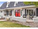 Inviting front porch with cozy seating and decorative flower pots that add to the curb appeal at 5440 W Hinsdale Ave, Littleton, CO 80128