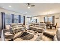 Open-concept living room featuring neutral tones, ample seating, and abundant natural light at 6863 E 132Nd Pl, Thornton, CO 80602