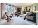 Bright living room with large windows, comfortable seating, and access to the staircase at 4257 Graham Ct, Boulder, CO 80305