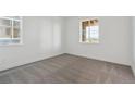 This bedroom has neutral carpet and two sunny windows at 8229 Butte Creek St, Littleton, CO 80125