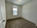 Cozy bedroom with plush carpeting and a bright window providing ample natural light at 5025 N Quemoy St, Aurora, CO 80019