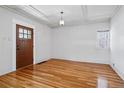 Bright living room with hardwood floors, coffered ceiling, and ample natural light at 618 S Franklin St, Denver, CO 80209