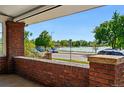 Scenic porch view overlooking a serene lake and tree-lined street at 618 S Franklin St, Denver, CO 80209