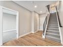 Inviting entryway featuring wood floors, staircase, and access to a room, creating a warm and welcoming atmosphere at 2323 Lakeshore Ln # 11, Superior, CO 80027