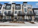 Attractive modern townhome exterior featuring private balconies and a stone and stucco facade at 2323 Lakeshore Ln # 11, Superior, CO 80027