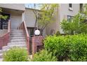 Inviting entrance with brick accents, a well-maintained lawn, and lush greenery leading to the front door at 345 Harrison St, Denver, CO 80206