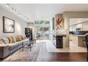 Cozy living room features a fireplace, skylights, and sliding glass doors to the outdoor patio at 345 Harrison St, Denver, CO 80206