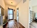 Bright entryway with hardwood floors, a decorative table, and views of the exterior at 295 Kitselman Dr, Castle Rock, CO 80104