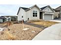 Charming home with a two-car garage, sidewalk, and low maintenance xeriscape at 295 Kitselman Dr, Castle Rock, CO 80104