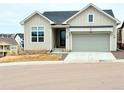 Charming home featuring a modern two-car garage, light siding, and inviting curb appeal at 295 Kitselman Dr, Castle Rock, CO 80104
