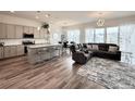 Open-concept living room featuring modern kitchen, dining area, and a cozy seating area at 295 Kitselman Dr, Castle Rock, CO 80104