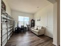 Bright living room with dark hardwood floors, built-in shelves, and lots of natural light at 295 Kitselman Dr, Castle Rock, CO 80104