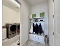 Organized mudroom entry with storage bench, shelving, and adjacent laundry area for convenience at 295 Kitselman Dr, Castle Rock, CO 80104