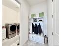 Convenient mudroom with built-in storage, coat hooks, and adjacent laundry area at 295 Kitselman Dr, Castle Rock, CO 80104