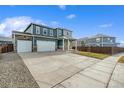 Two-story house with a three-car garage and landscaped yard at 4410 Cattle Cross Rd, Castle Rock, CO 80104