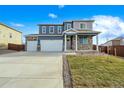 Two-story home with a three-car garage and stone accents at 4410 Cattle Cross Rd, Castle Rock, CO 80104