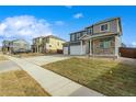 Two-story house with stone and siding exterior, large driveway at 4410 Cattle Cross Rd, Castle Rock, CO 80104