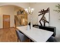 Bright dining area adjacent to the staircase featuring hardwood floors and stylish furnishings at 14910 Williams St, Thornton, CO 80602