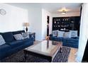 Comfortable living room featuring two sofas, a stylish coffee table, and hardwood floors at 413 Jamaica St, Aurora, CO 80010