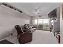 Comfortable living room with plush leather seating, a fireplace, and a sliding door to the balcony at 9318 Las Ramblas Ct # R, Parker, CO 80134