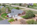 Aerial view of home showing roof, landscaping, and outbuildings at 15020 Harrison St, Brighton, CO 80602