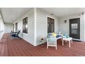 Inviting front porch with comfortable seating, stylish decor, and ample space for relaxing at 15020 Harrison St, Brighton, CO 80602