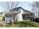 Charming two-story home with a manicured lawn and attached two-car garage at 10774 W 107Th Cir, Broomfield, CO 80021