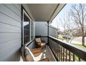 Relaxing covered porch with comfortable wicker chairs and wood railing at 10774 W 107Th Cir, Broomfield, CO 80021