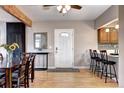 Inviting entryway showcases a mirror, hardwood floors, and seamless transition to the kitchen with bar seating at 7877 S University Way, Centennial, CO 80122