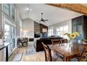 Inviting living room with vaulted ceiling, a stone fireplace, and a wall of windows for ample natural light at 7877 S University Way, Centennial, CO 80122