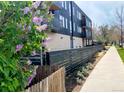 Modern apartment building with black wood and balconies along a sidewalk at 2718 Pine St # 305, Boulder, CO 80302