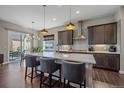 Modern kitchen with island and stainless steel appliances at 22537 E Swallow Pl, Aurora, CO 80016