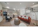 Stylish living room featuring an open floor plan, modern kitchen, and contemporary staircase design at 1372 Lowell Blvd # 4, Denver, CO 80204