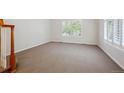 Bright bedroom with carpet flooring and shuttered windows at 11969 E Lake Cir, Greenwood Village, CO 80111