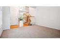 Spacious living room with hardwood and carpet flooring and staircase at 11969 E Lake Cir, Greenwood Village, CO 80111
