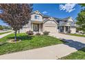 Inviting two-story home with a manicured lawn, complemented by a two-car garage and picturesque landscaping at 4405 Walden Ct, Denver, CO 80249