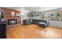 Spacious living room with a cozy fireplace, hardwood floors, and a large sectional sofa for comfortable living at 3002 S Fenton St, Denver, CO 80227