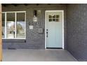Charming front door with glass panes, a black mailbox, and the house number displayed above at 4320 Lamar St, Wheat Ridge, CO 80033