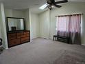 Spacious bedroom featuring a ceiling fan and large window letting in natural light at 12738 E Wyoming Cir, Aurora, CO 80012