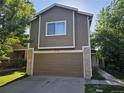 Exterior shot showcasing a two-story home with an attached garage and sidewalk at 12738 E Wyoming Cir, Aurora, CO 80012